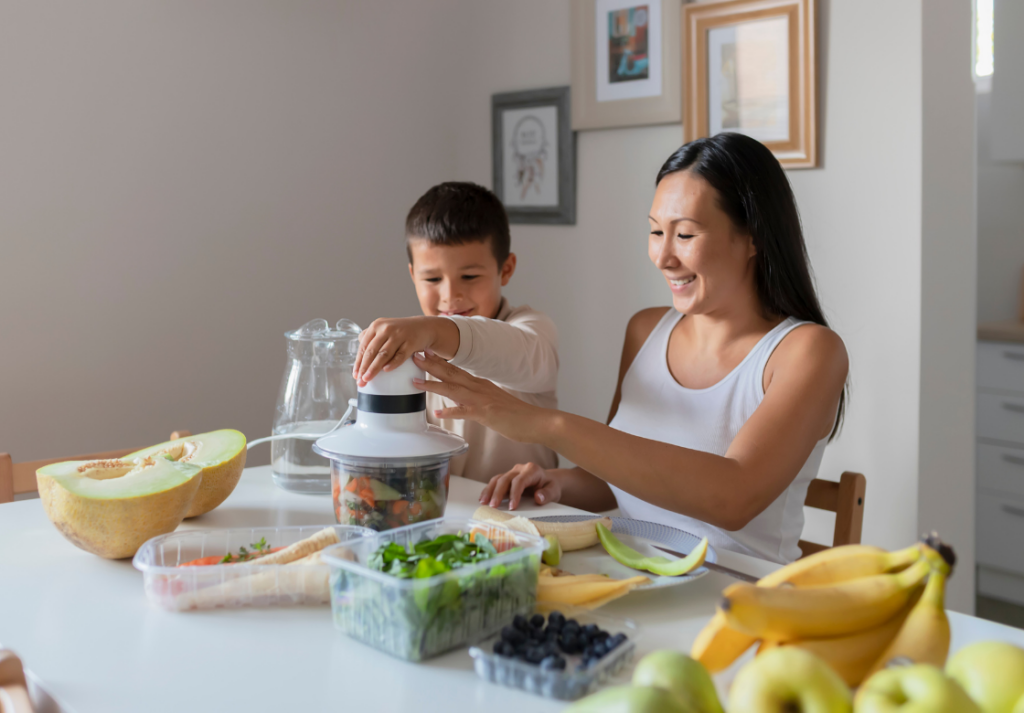 family juicing and eating salad around a table