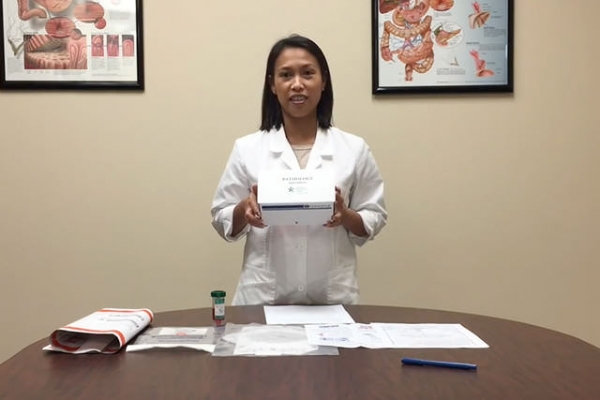 Lady presenting white box to viewer