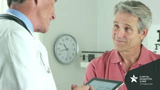 Patient talking with doctor holding ipad