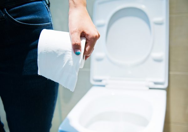 person holding toilet paper