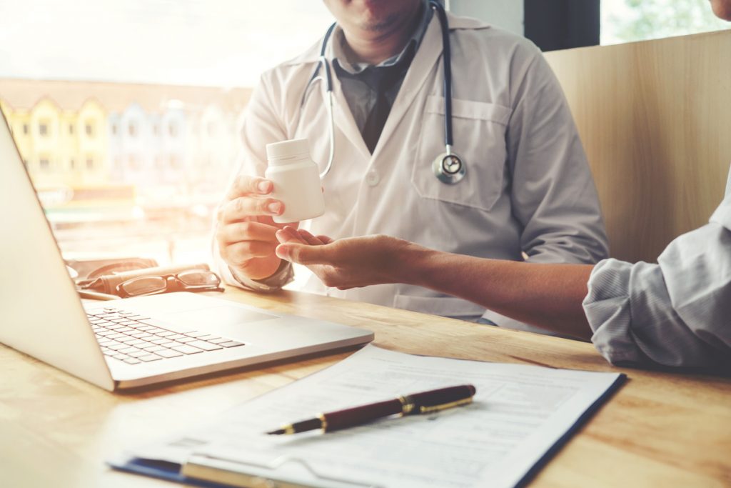 Doctor giving patient a heartburn medication sample