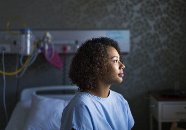 A young woman with colon cancer in a doctor's office waiting to get a colonoscopy.